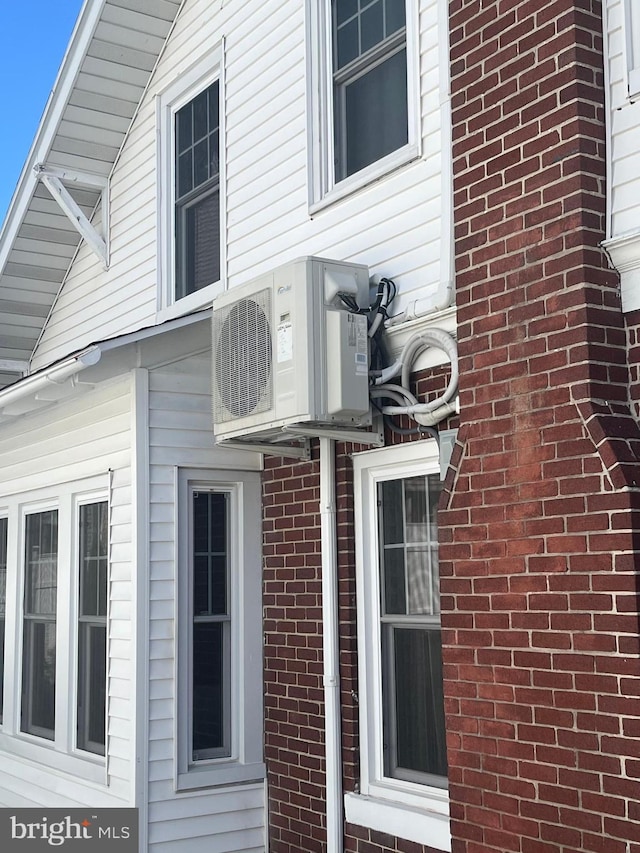 view of property exterior featuring ac unit and brick siding