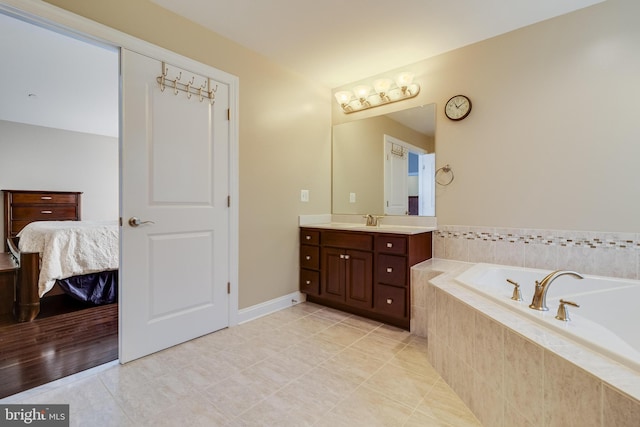 full bathroom featuring a garden tub, ensuite bathroom, tile patterned flooring, and vanity