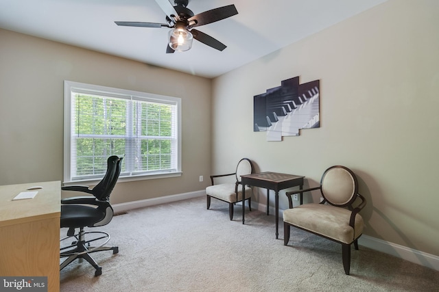 office area with a ceiling fan, baseboards, and carpet