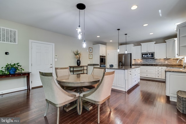 dining space featuring dark wood-style flooring, baseboards, visible vents, and recessed lighting