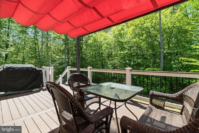 wooden terrace featuring outdoor dining space and a grill