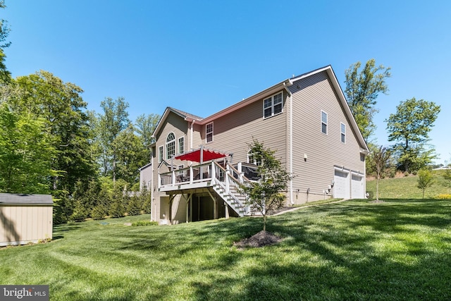 rear view of house with stairs, a garage, a lawn, and a deck