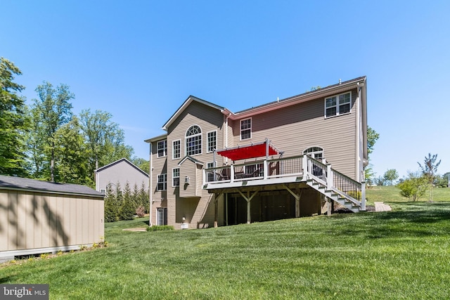back of property with a lawn, a wooden deck, and stairs