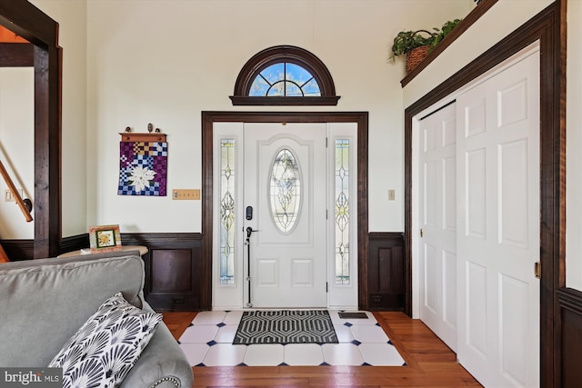 5211 Al Jones Dr, Shady Side, MD 20764 - foyer with wood finished floors, a decorative wall, and wainscoting