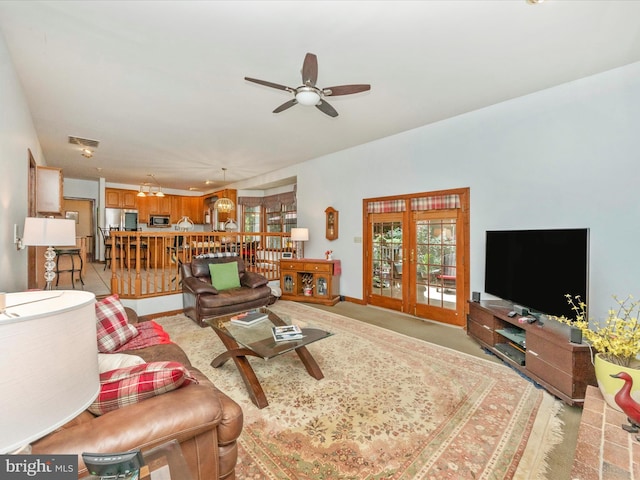 living room with baseboards, ceiling fan, french doors, and a healthy amount of sunlight