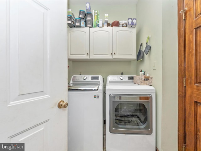 clothes washing area with cabinet space and washer and dryer