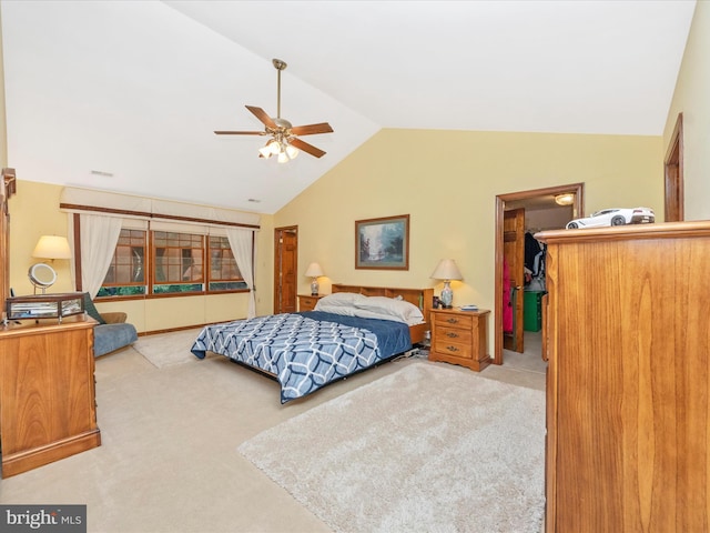 carpeted bedroom with a walk in closet, vaulted ceiling, and ceiling fan