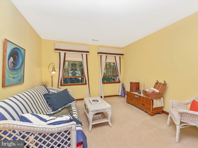 carpeted living room featuring baseboards and visible vents