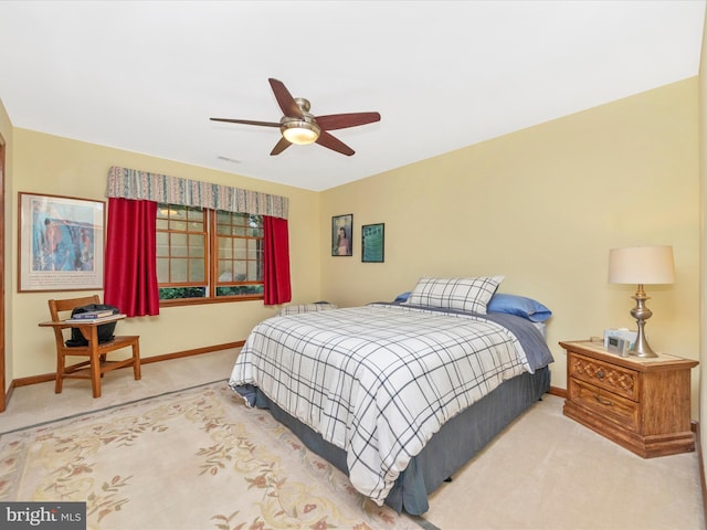 carpeted bedroom featuring baseboards, ceiling fan, and visible vents