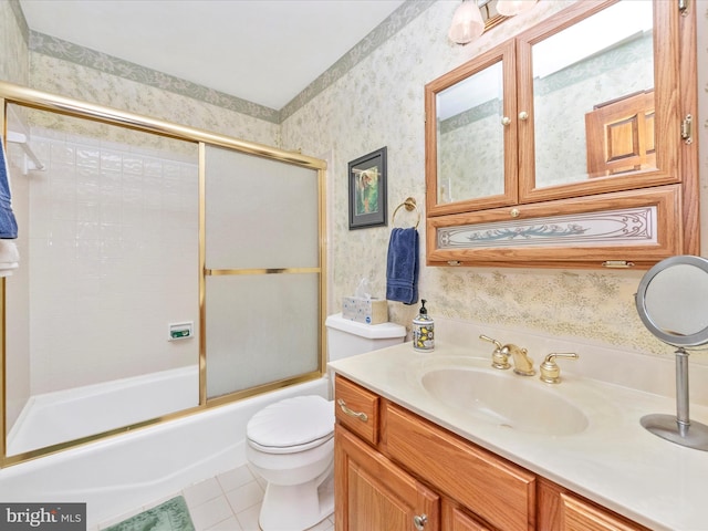 bathroom with tile patterned flooring, shower / bath combination with glass door, vanity, toilet, and wallpapered walls