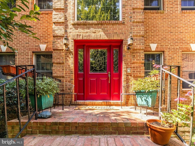 property entrance featuring brick siding