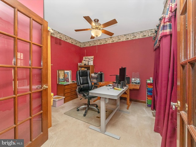 home office featuring a ceiling fan, visible vents, and carpet