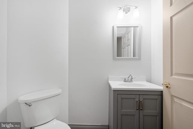half bath featuring toilet and vanity
