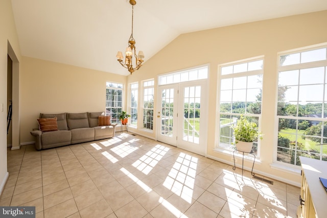 sunroom featuring plenty of natural light, a chandelier, french doors, and vaulted ceiling