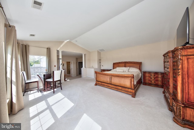 bedroom featuring light carpet and lofted ceiling