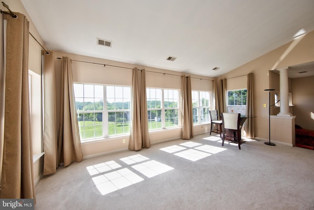 sitting room featuring carpet flooring, plenty of natural light, decorative columns, lofted ceiling, and baseboards