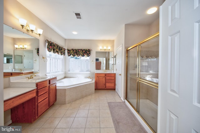 bathroom with tile patterned flooring, a stall shower, a bath, and two vanities