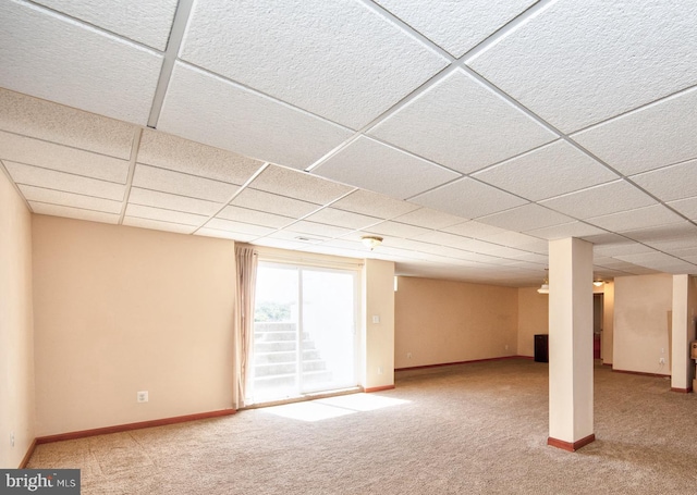 below grade area featuring carpet, a paneled ceiling, and baseboards
