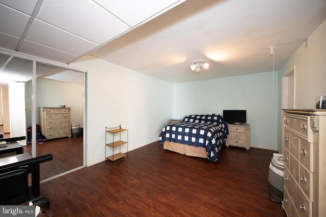 bedroom featuring wood finished floors and baseboards