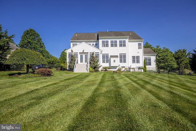 back of house featuring a lawn