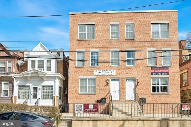 multi unit property with brick siding and fence