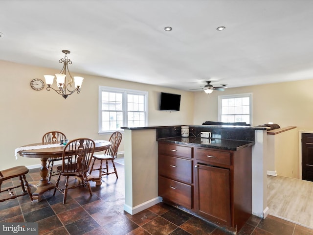 202 Glade Blvd, Walkersville, MD 21793 - kitchen featuring a center island, dark stone countertops, baseboards, ceiling fan with notable chandelier, and pendant lighting