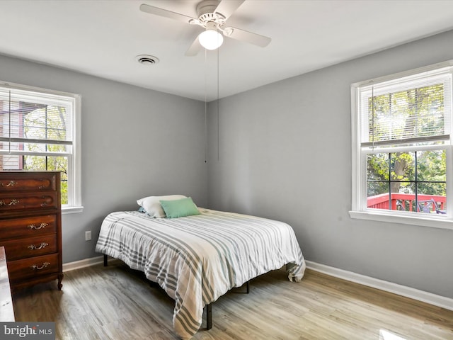 202 Glade Blvd, Walkersville, MD 21793 - bedroom with baseboards, wood finished floors, visible vents, and multiple windows
