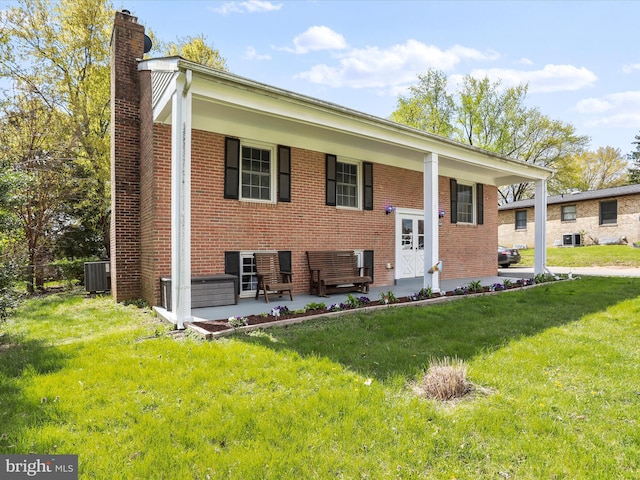 202 Glade Blvd, Walkersville, MD 21793 - split foyer home with a chimney, a front lawn, brick siding, and central AC unit