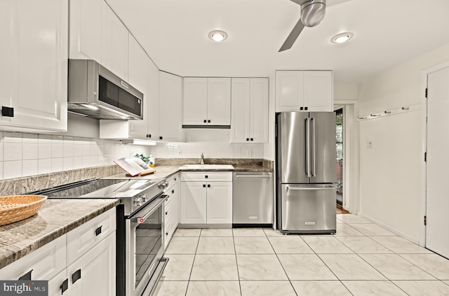 2646 S June St, Arlington, VA 22202 - kitchen featuring appliances with stainless steel finishes, a sink, white cabinets, and backsplash