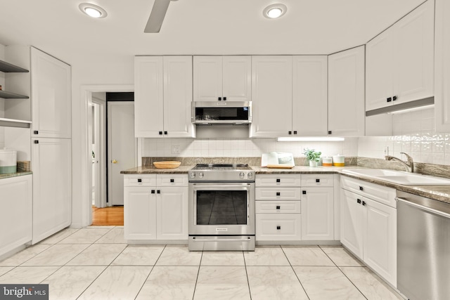 2646 S June St, Arlington, VA 22202 - kitchen featuring stainless steel appliances, a sink, open shelves, white cabinetry, and recessed lighting