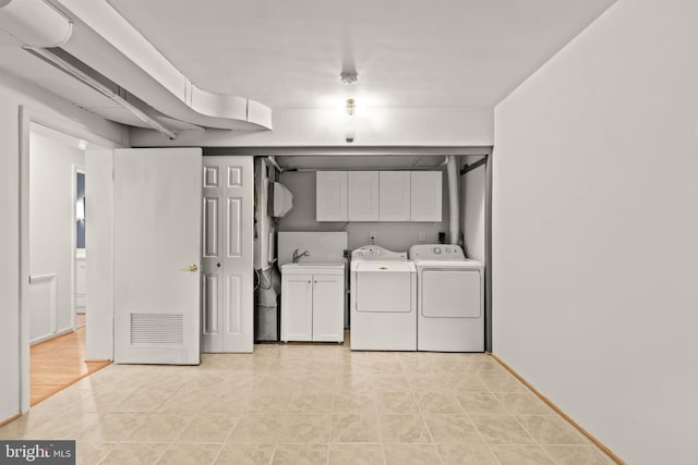 2646 S June St, Arlington, VA 22202 - washroom with cabinet space, washing machine and dryer, light tile patterned flooring, and baseboards