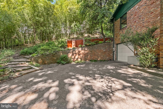2646 S June St, Arlington, VA 22202 - view of patio featuring driveway and an attached garage