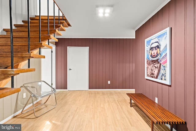 2646 S June St, Arlington, VA 22202 - unfurnished room featuring wood finished floors, stairs, crown molding, baseboards, and wood walls