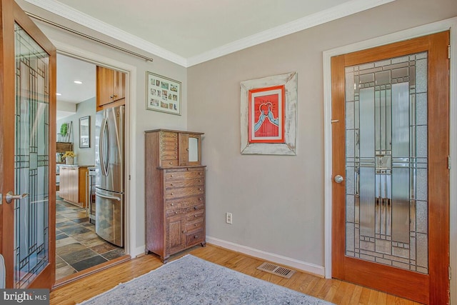 2801 Riva Rd, Annapolis, MD 21401 - entryway featuring baseboards, crown molding, wood finished floors, and visible vents