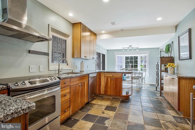 2801 Riva Rd, Annapolis, MD 21401 - kitchen featuring wall chimney exhaust hood, stainless steel appliances, a peninsula, stone tile flooring, and a sink