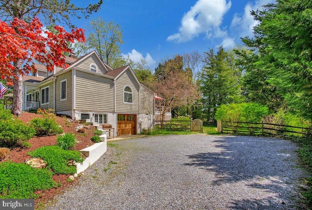 2801 Riva Rd, Annapolis, MD 21401 - view of side of home featuring a garage, gravel driveway, and fence
