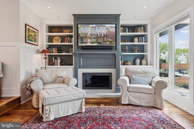 15 Chesapeake Lndg, Annapolis, MD 21403 - living area featuring crown molding, a fireplace with flush hearth, wood finished floors, built in features, and recessed lighting