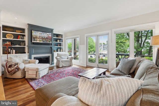 15 Chesapeake Lndg, Annapolis, MD 21403 - living room featuring ornamental molding, wood finished floors, a glass covered fireplace, and built in shelves
