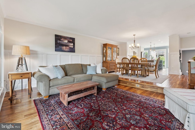 15 Chesapeake Lndg, Annapolis, MD 21403 - living room featuring a chandelier, light wood-style flooring, a wainscoted wall, a decorative wall, and ornamental molding