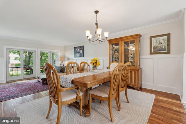15 Chesapeake Lndg, Annapolis, MD 21403 - dining room with a chandelier, a decorative wall, crown molding, light wood finished floors, and a wainscoted wall