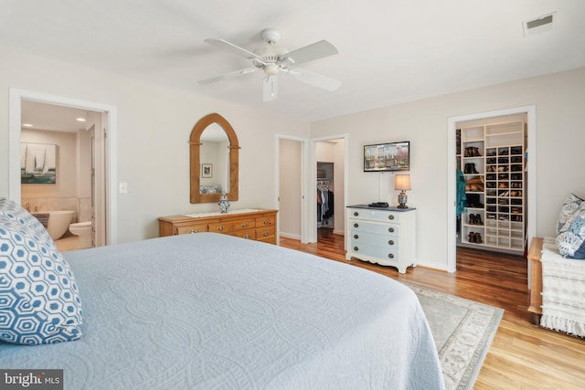 15 Chesapeake Lndg, Annapolis, MD 21403 - bedroom with a walk in closet, a closet, wood finished floors, ensuite bathroom, and ceiling fan