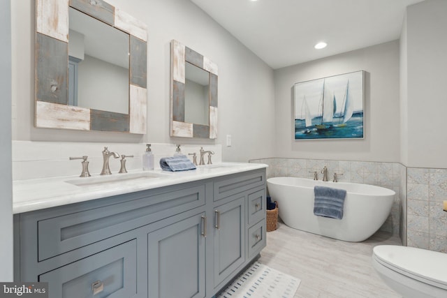 15 Chesapeake Lndg, Annapolis, MD 21403 - full bath with tile walls, a freestanding bath, wainscoting, double vanity, and wood finished floors