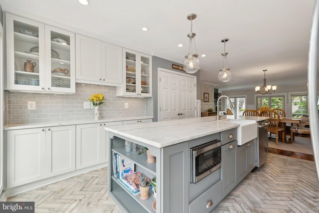 15 Chesapeake Lndg, Annapolis, MD 21403 - kitchen with gray cabinetry, a sink, appliances with stainless steel finishes, backsplash, and white cabinets