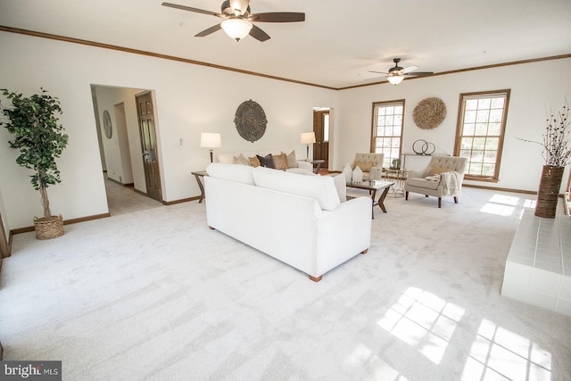 living room with light carpet, ornamental molding, and ceiling fan