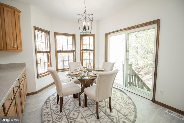 dining area with visible vents, baseboards, and a notable chandelier