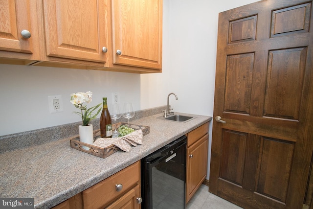 kitchen with light tile patterned floors, a sink, and black dishwasher