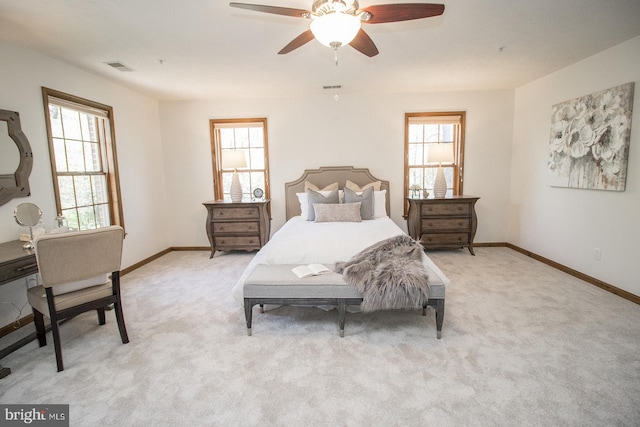 bedroom with light carpet, visible vents, and baseboards