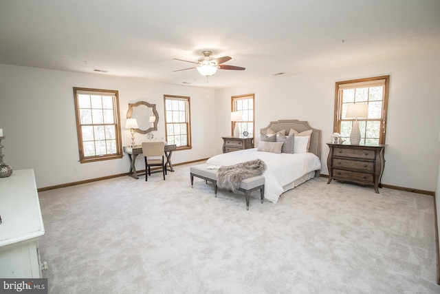 bedroom with visible vents, baseboards, a ceiling fan, and light colored carpet