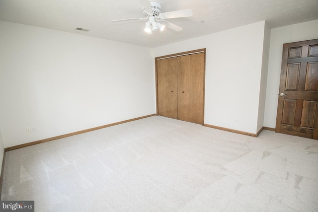 unfurnished bedroom with visible vents, baseboards, and light colored carpet