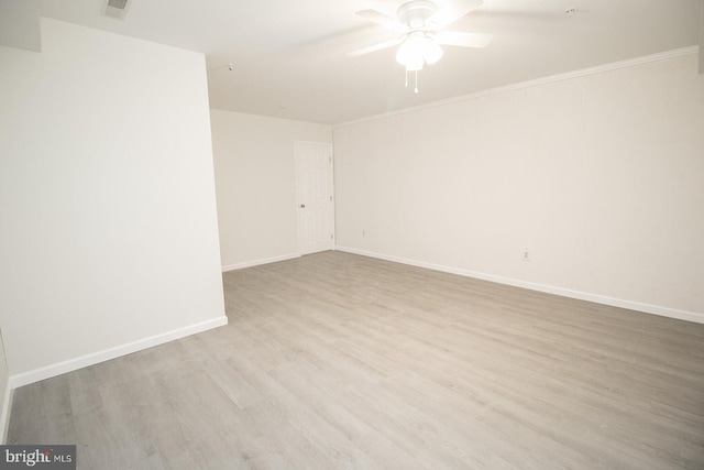 unfurnished room with visible vents, baseboards, a ceiling fan, and wood finished floors
